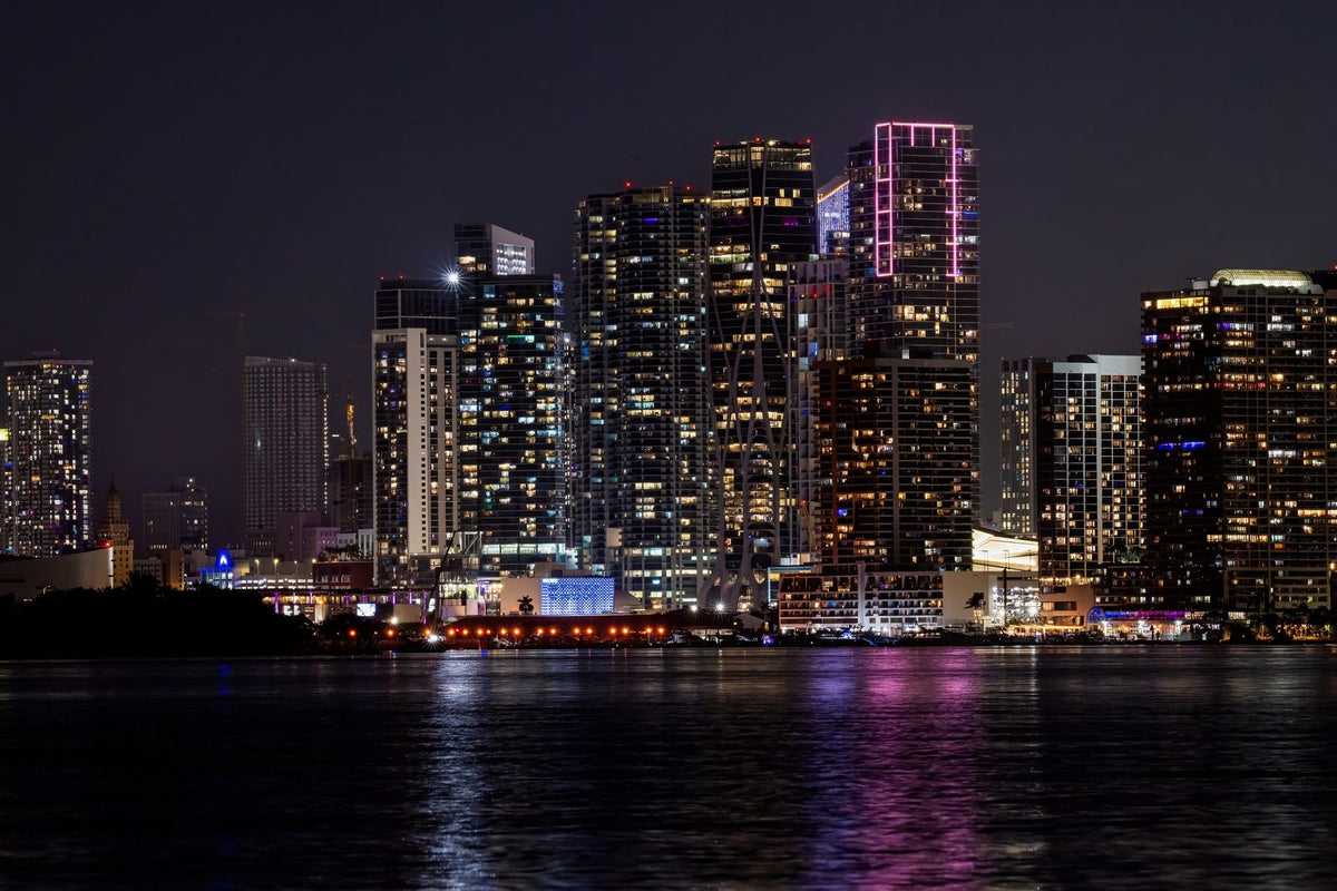 Downtown Miami skyline lit up at night across the water
