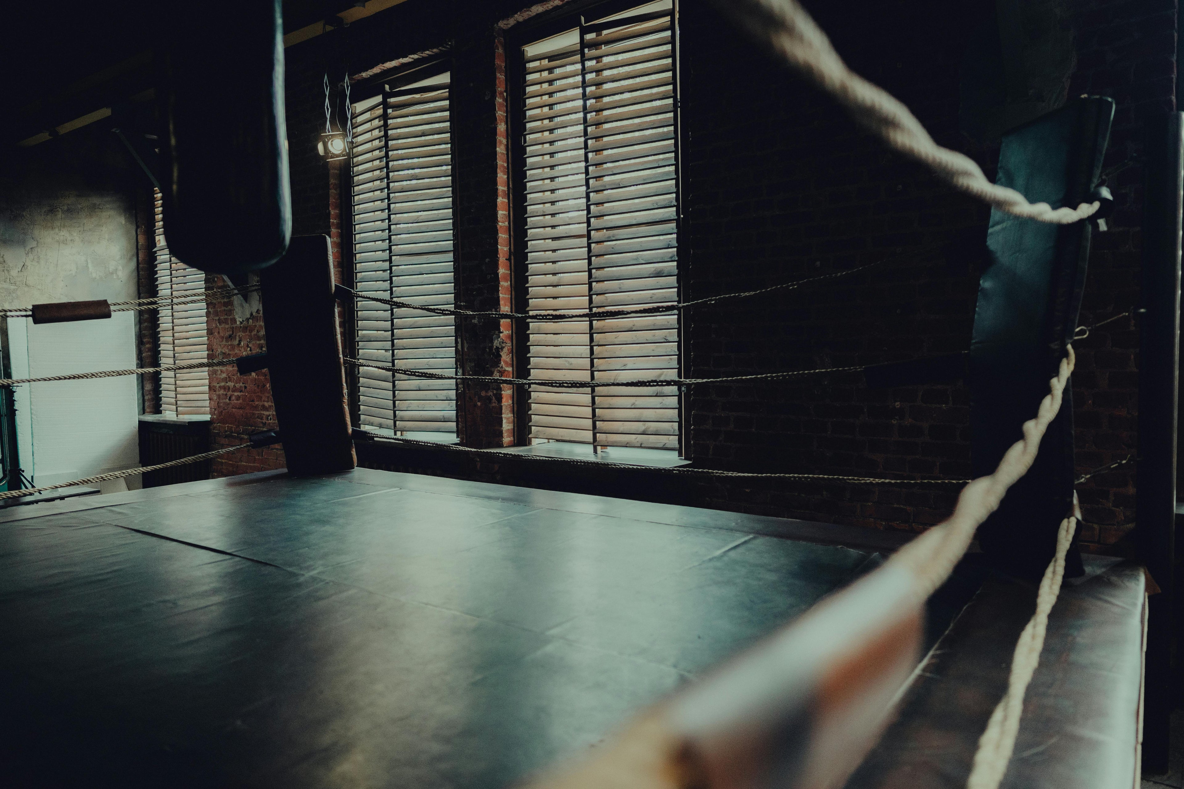 Atmospheric empty boxing ring with moody lighting